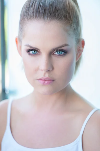 Blue eyed young woman staring intently — Stock Photo, Image