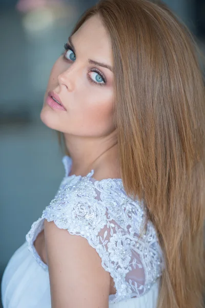 Beautiful serious young woman with blue eyes — Stock Photo, Image