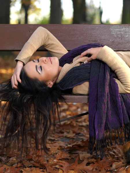 Long Hair Woman Sleeping on Bench in Autumn Outfit — Stock Photo, Image