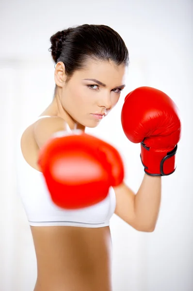 Determined woman wearing red boxing gloves — Stock Photo, Image