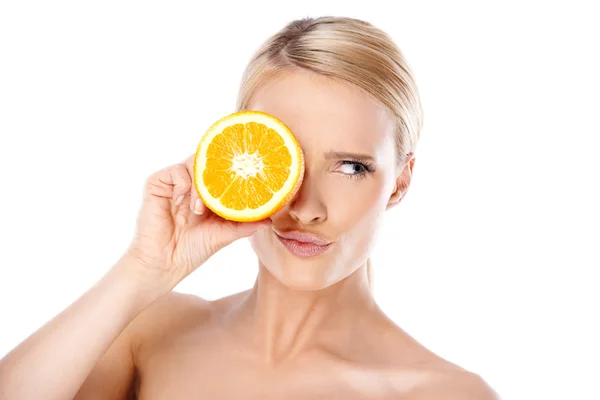 Young Woman Putting Slice of Lemon Over the Eye Royalty Free Stock Images