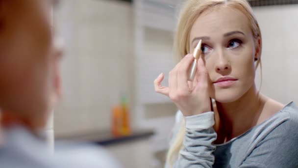 Pretty Blond Woman Applying Eyebrow Makeup — Stock Video