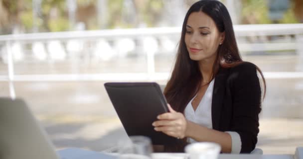 Mujer de negocios bastante trabajando en una tableta — Vídeo de stock