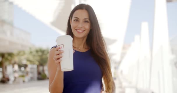 Attractive woman holding a large cup of coffee — Stock Video