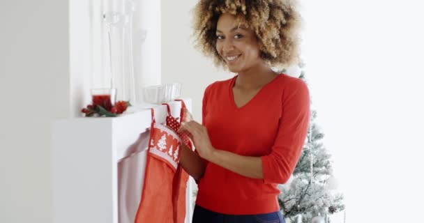 Woman hanging Christmas stockings — Stockvideo