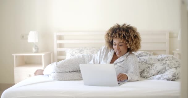 Chica acostada en la cama y navegar por Internet — Vídeo de stock