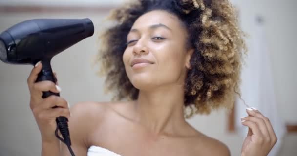 Girl drying hair in bathroom — Stock Video