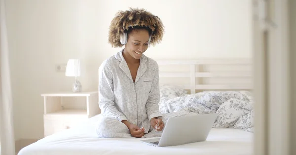 Vrouw met laptop op bed — Stockfoto