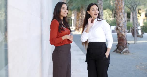 Business women standing together watching something — стоковое видео