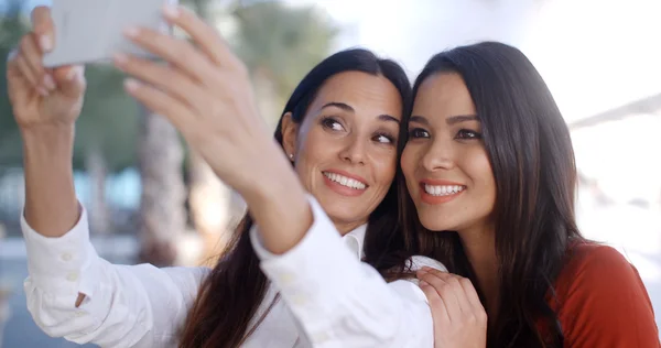 Women posing for selfie on mobile phone — Stok fotoğraf