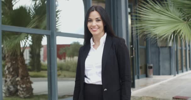 Businesswoman standing outside commercial building — Stock video