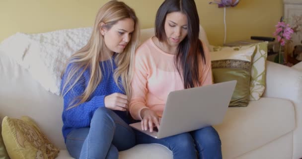 Women browsing internet on laptop at home — Stock Video
