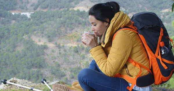 Female backpacker enjoying mug of coffee — Stockfoto
