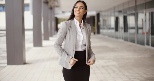 Businesswoman standing next to modern office — Stok fotoğraf