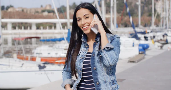 Woman chatting on phone on waterfront promenade — Stock Fotó