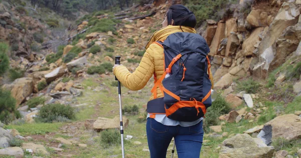 Woman walking on hiking trail in mountains — 스톡 사진