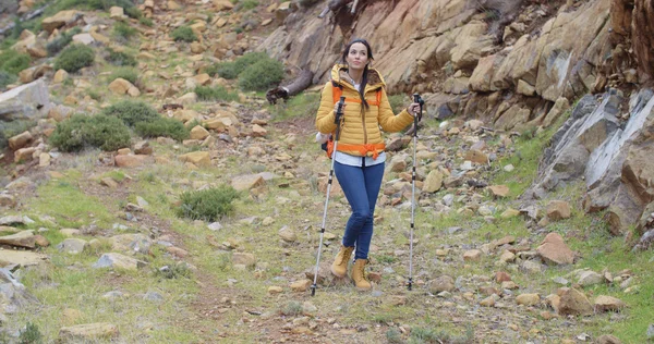 Woman walking on hiking trail in mountains — 스톡 사진