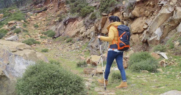 Woman walking on hiking trail in mountains — 스톡 사진