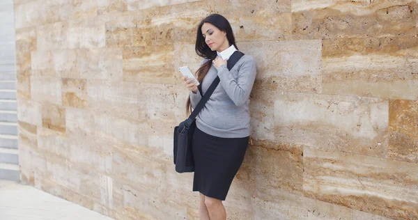 Businesswoman checking email on phone outdoors — Stock Photo, Image