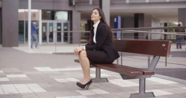 Business woman sitting alone on bench — стоковое видео