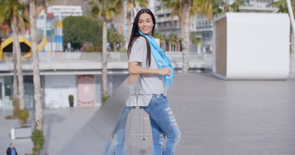 Woman wearing jeans and blue scarf — Stock Photo, Image