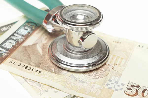 Stethoscope on the top of the money — Stock Photo, Image