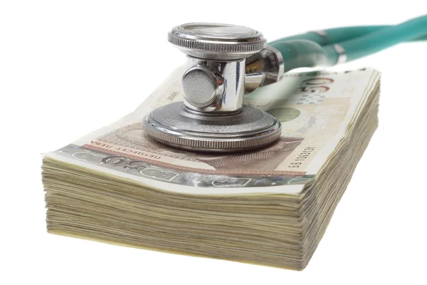 Stethoscope on the top of the money — Stock Photo, Image