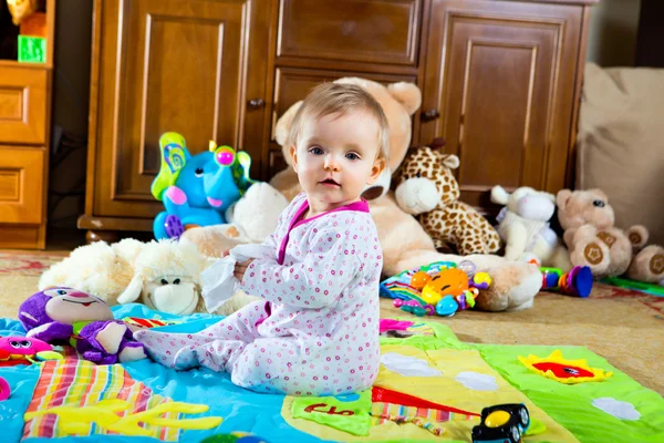 Baby on the carpet with toys — Stock Photo, Image