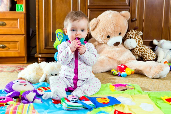 Baby on the carpet with toys — Stock Photo, Image