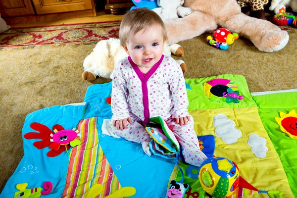 Baby on the carpet with toys — Stock Photo, Image