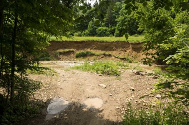 effects of a river erosion process in a hilly terrain