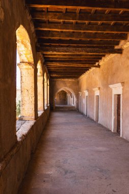 a long, empty corridor in a historic building