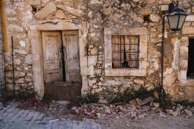 an old window in a stone wall seen from the outside of the building