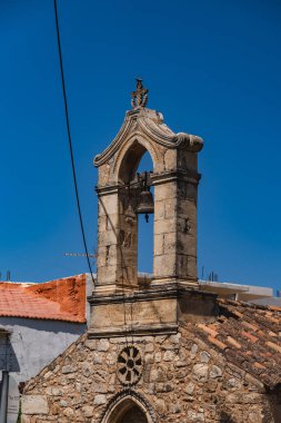 close-up of a church bell tower against a blue sky