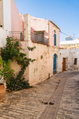 a narrow street in the small Greek town of Margarites on the island of Crete