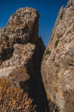 Rock slopes covered with withered vegetation during the dry season