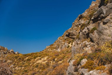 Rock slopes covered with withered vegetation during the dry season