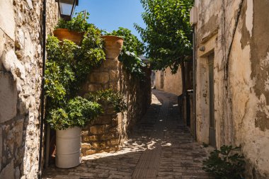 a narrow street in the small Greek town of Margarites on the island of Crete