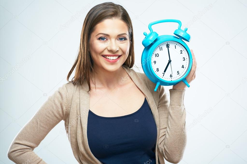 woman holds alarm clock