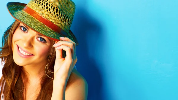 Woman with toothy smile touching hat — Stock Photo, Image