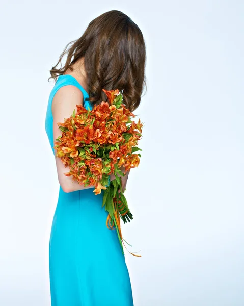 woman posing with bouquet of flowers