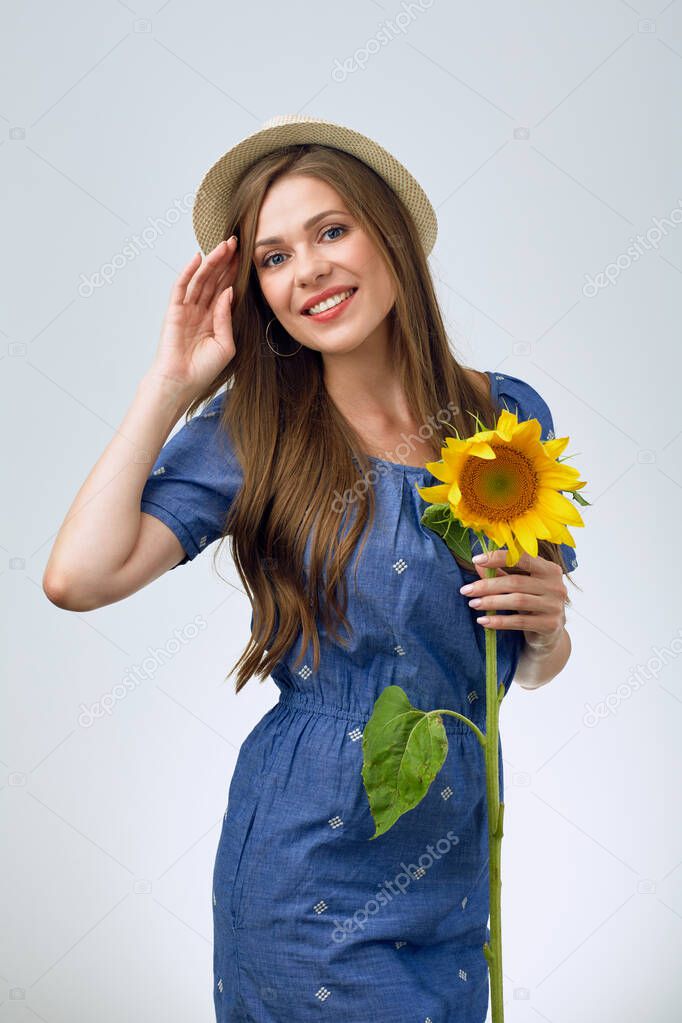 isolated portrait of beautiful girl holding one sunflower.
