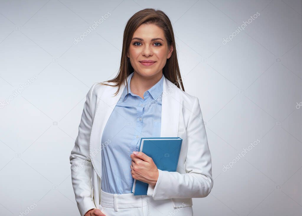 Business woman in white suit holding books. Isolated portrait one female person.
