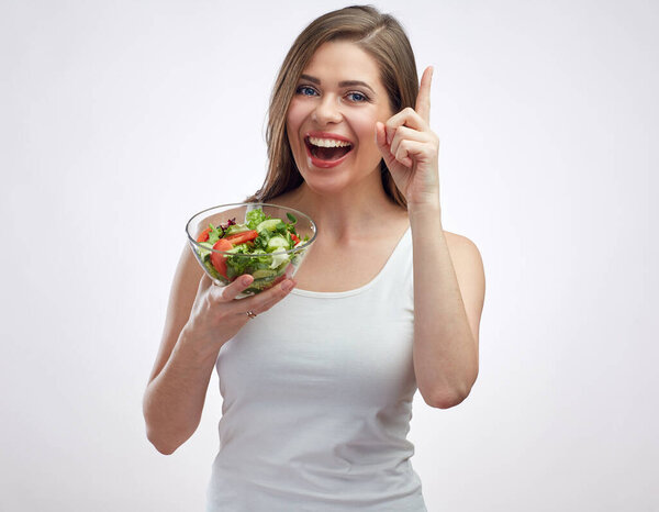 Finger pointing up. Healthy lifestyle isolated portrait of smiling woman holding vegetable salad.