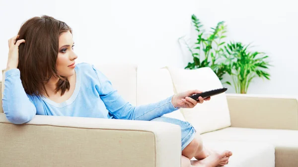 Woman sitting on sofa — Stock Photo, Image