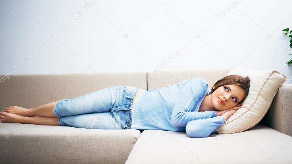 Beautiful woman lying on sofa.