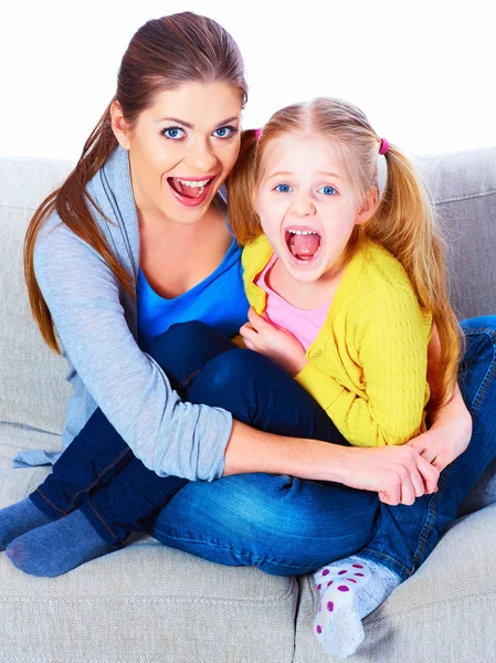 Mother with daughter sitting on sofa — Stock Photo, Image