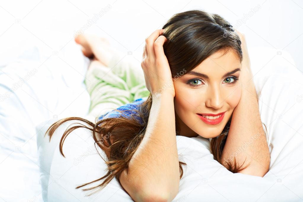 Young woman resting in bed.