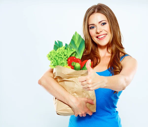 Woman holding paper bag with vegetables — Stock Photo, Image