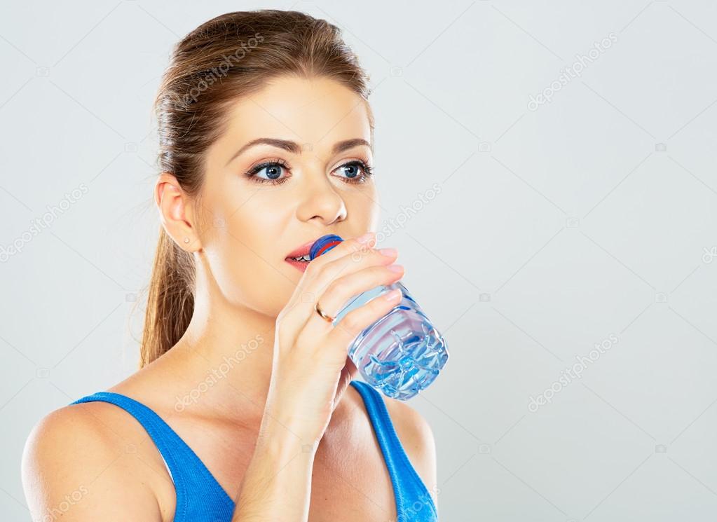 Active woman drinking water